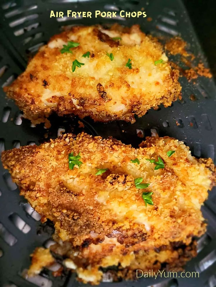 air fryer pork chops with parmesan cheese and herbs on the top