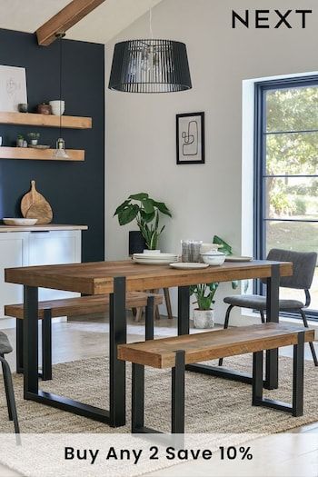 a dining room table with two benches next to it