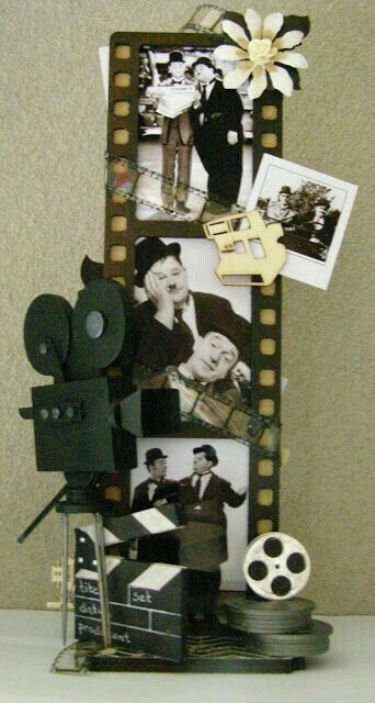 an old movie strip with pictures and film reels on it, sitting on a table