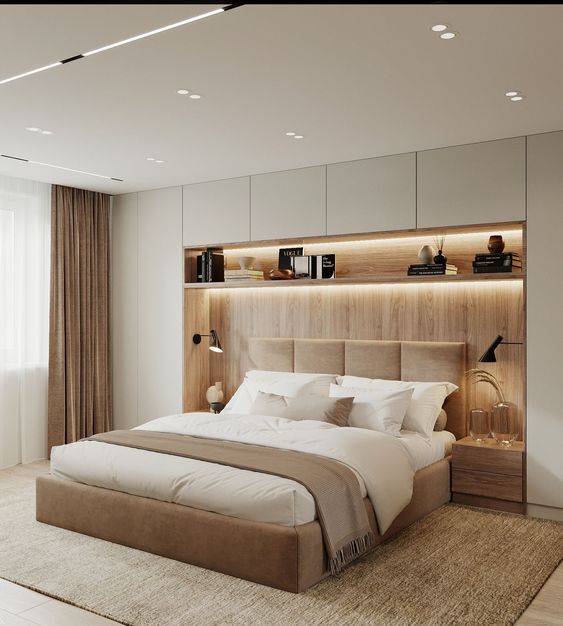 a bedroom with a large bed and built in shelves on the wall next to it