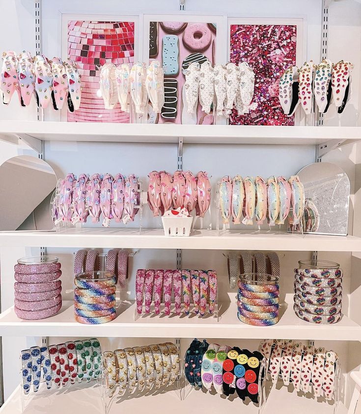 the shelves are filled with different types of bracelets and other jewelry items on display