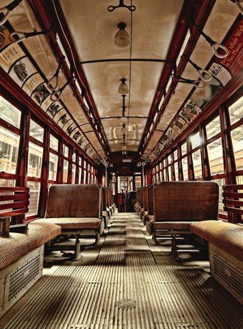 the inside of a train car with benches and tables in it's center circle