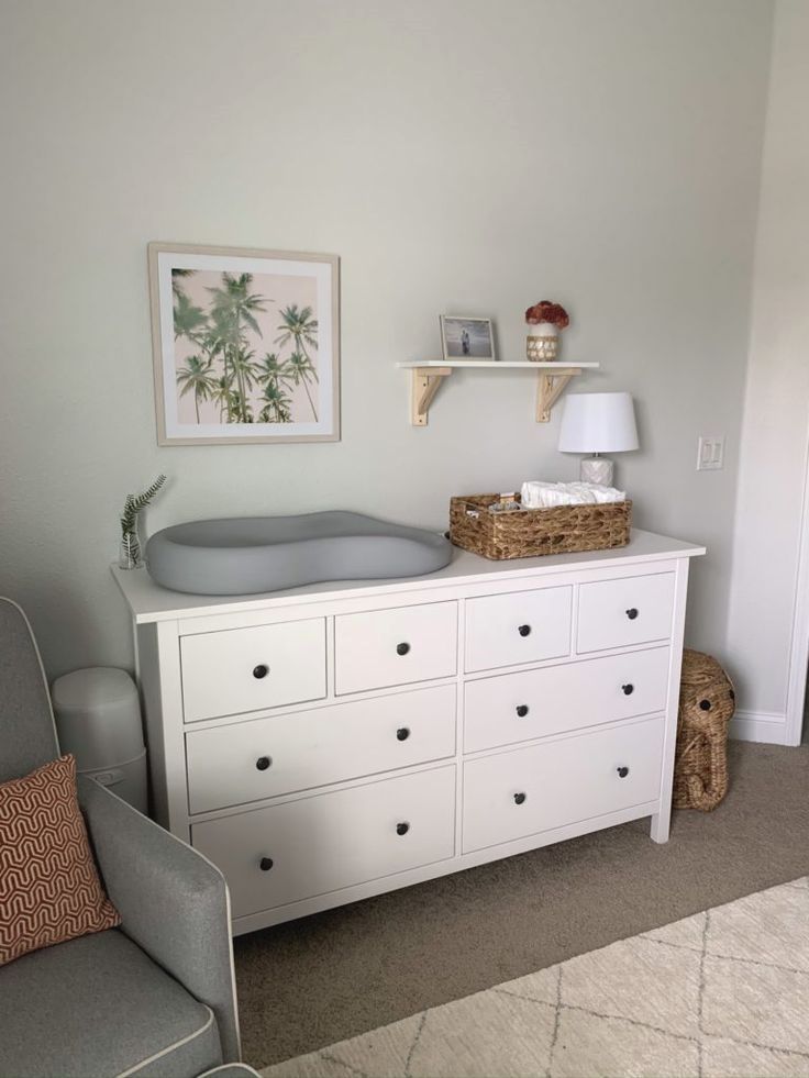 a baby's room with a crib and dresser