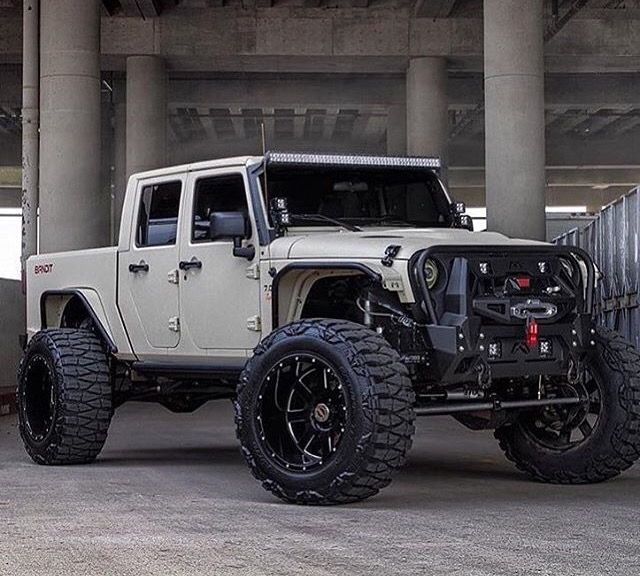 a white jeep is parked in an empty parking garage with lots of space to put it's wheels on