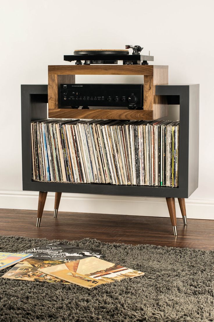 an old record player sitting on top of a cabinet