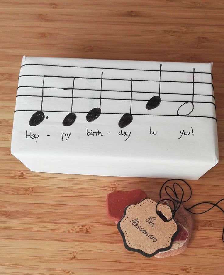 a cake that is decorated to look like music notes and has a tag on it