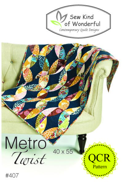 a couch with a quilt on it and the words metro twist written in front of it