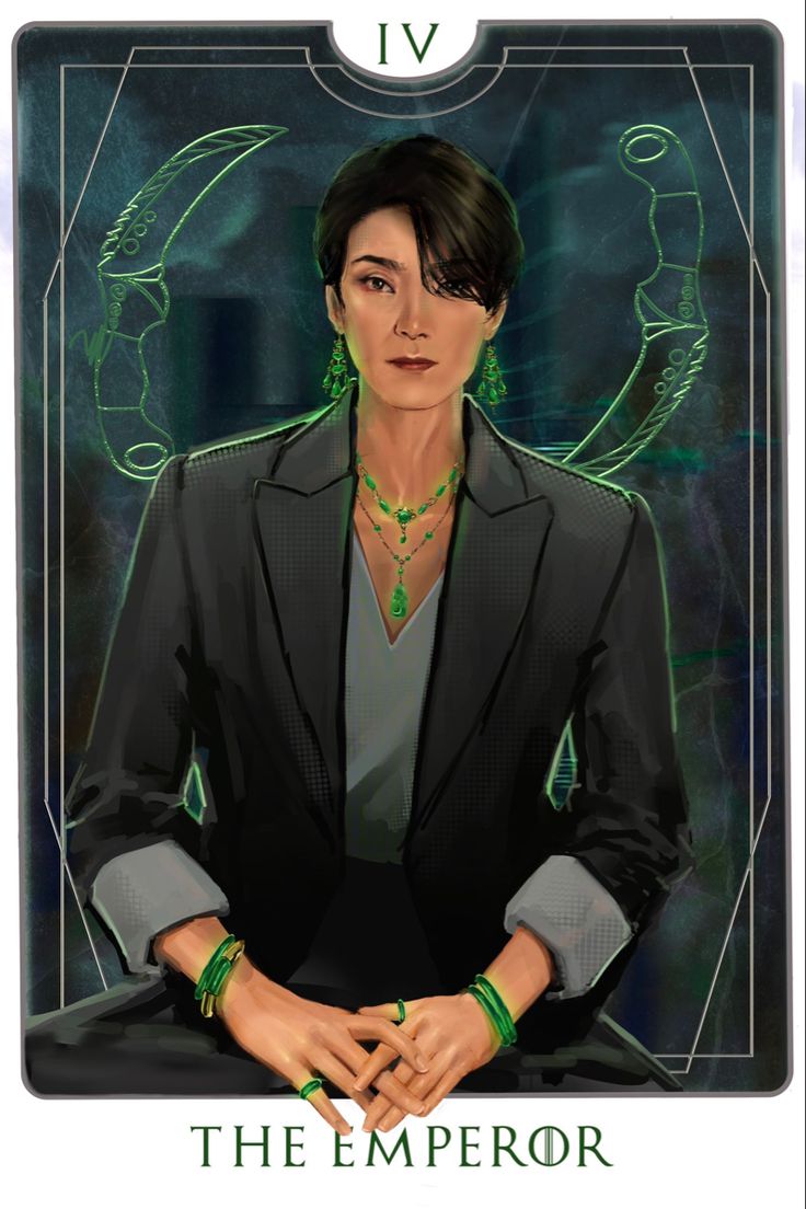 an image of a woman in a suit with green jewelry on her neck and hands crossed