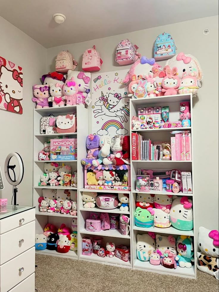 a room filled with lots of hello kitty stuffed animals and bookshelf full of toys