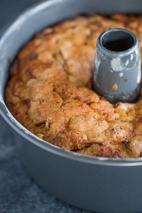 a close up of a cake in a pan with a candle sticking out of it