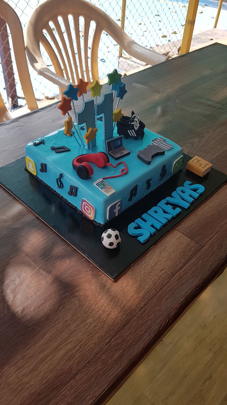 a birthday cake that is on top of a table with a soccer ball and other items