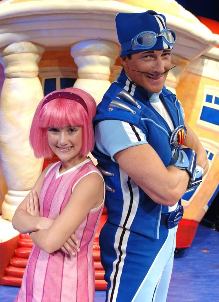 two people dressed in costumes posing for a photo on the set of an animated movie