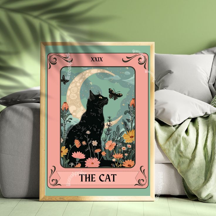 a black cat sitting on top of a white couch next to a green wall with a pink frame