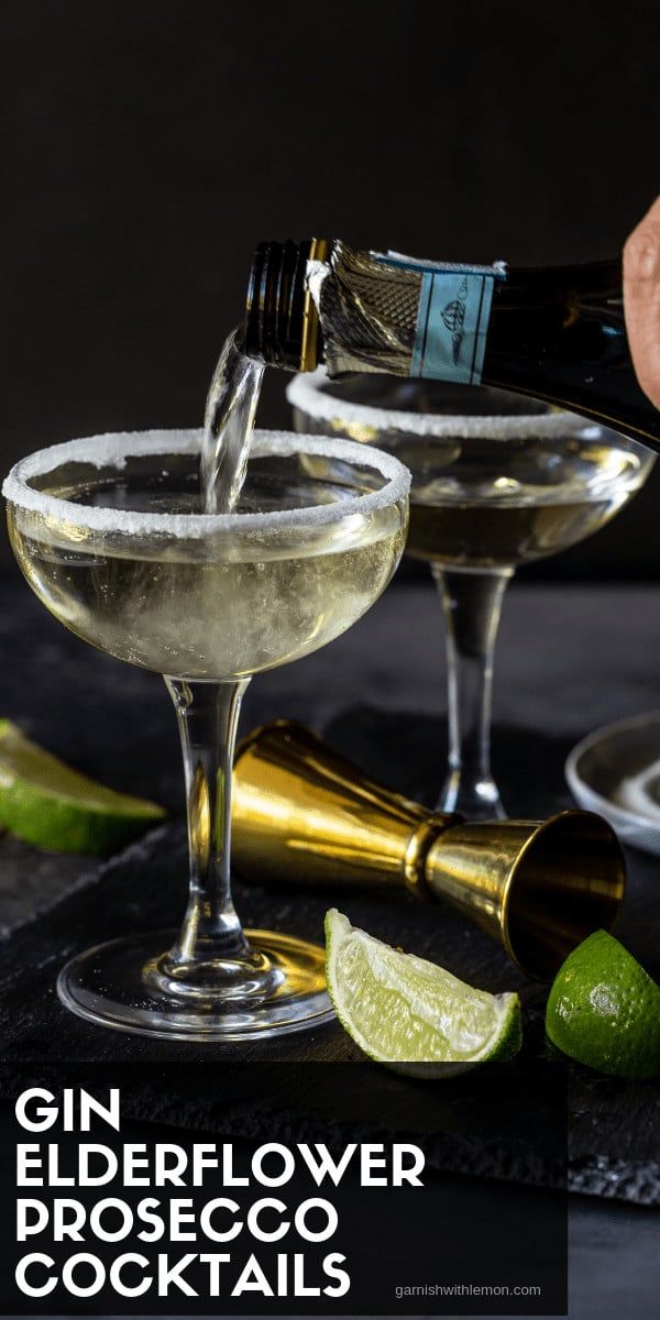 the gin elderflower prosciuco cocktail is being poured into two coupe glasses