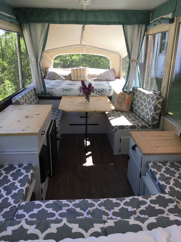 the inside of a camper with couches and tables