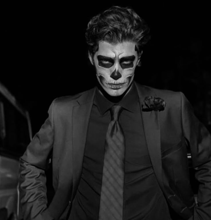 a man dressed up in a skeleton mask and tie