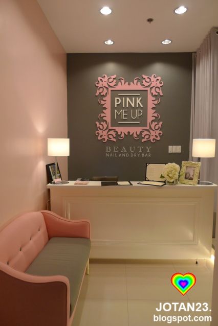 a pink and gray reception area with a bench