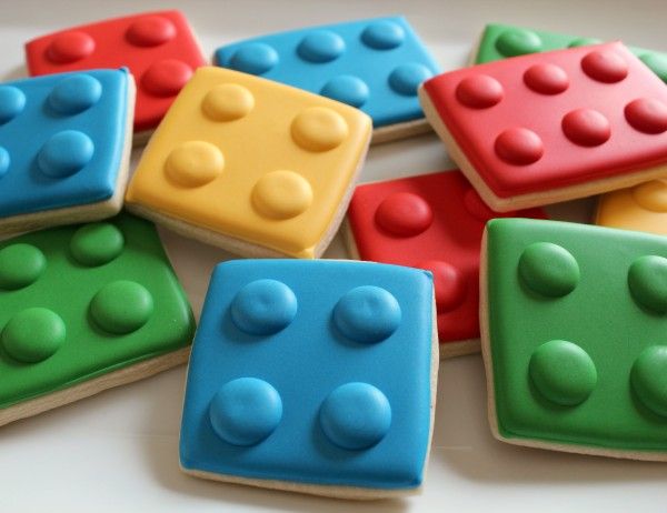 lego themed cookies are arranged on a plate