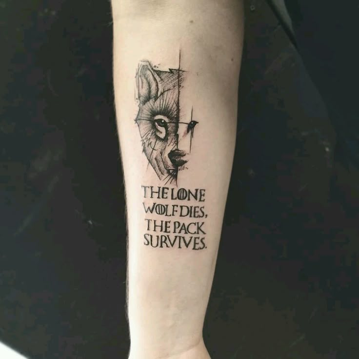 a person with a tattoo on their arm that reads, the lone wolf rides the pack survive