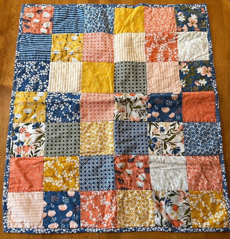 an old patchwork quilt is laying on the floor