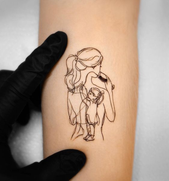 a woman's arm with a drawing of a mother and her child on it