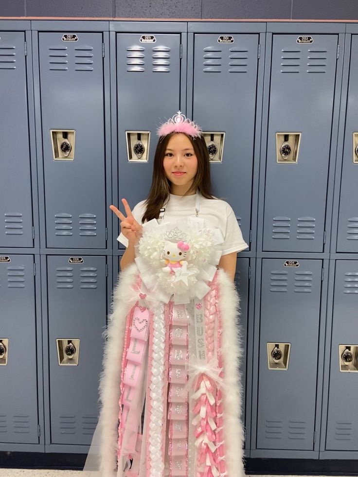 a girl standing in front of lockers wearing a pink and white dress