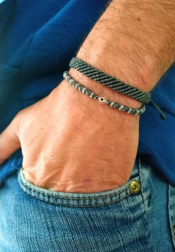 a man wearing a bracelet with silver beads