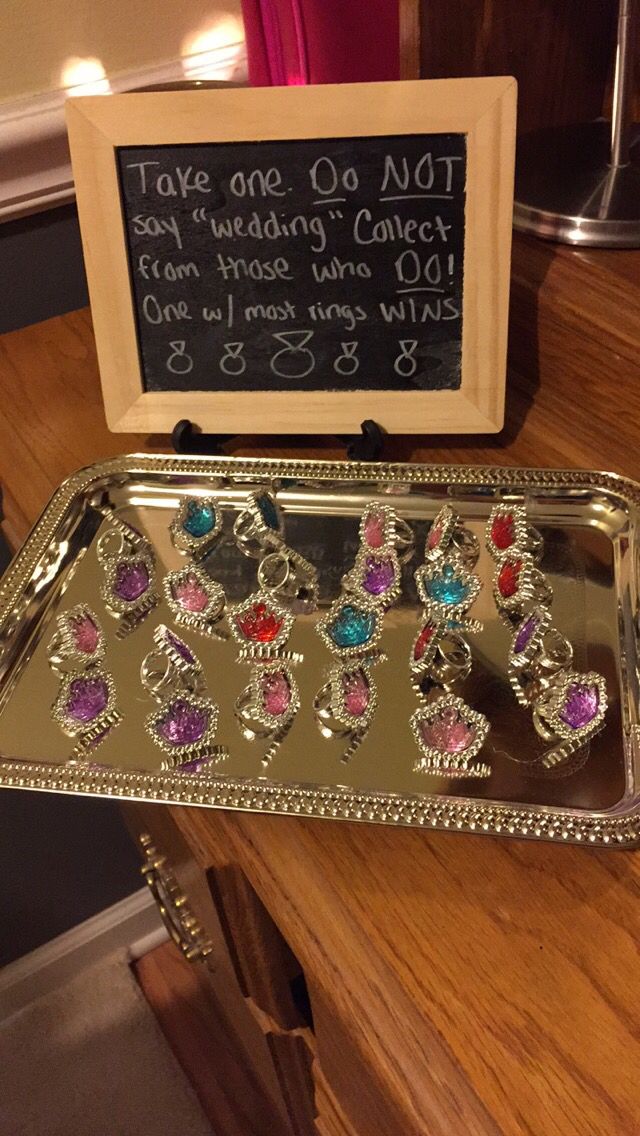 a metal tray with some colorful jewels on it next to a sign that says take one or not