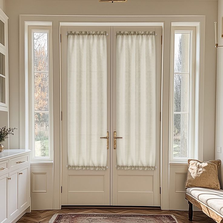 a large white door with two windows and a rug on the floor in front of it