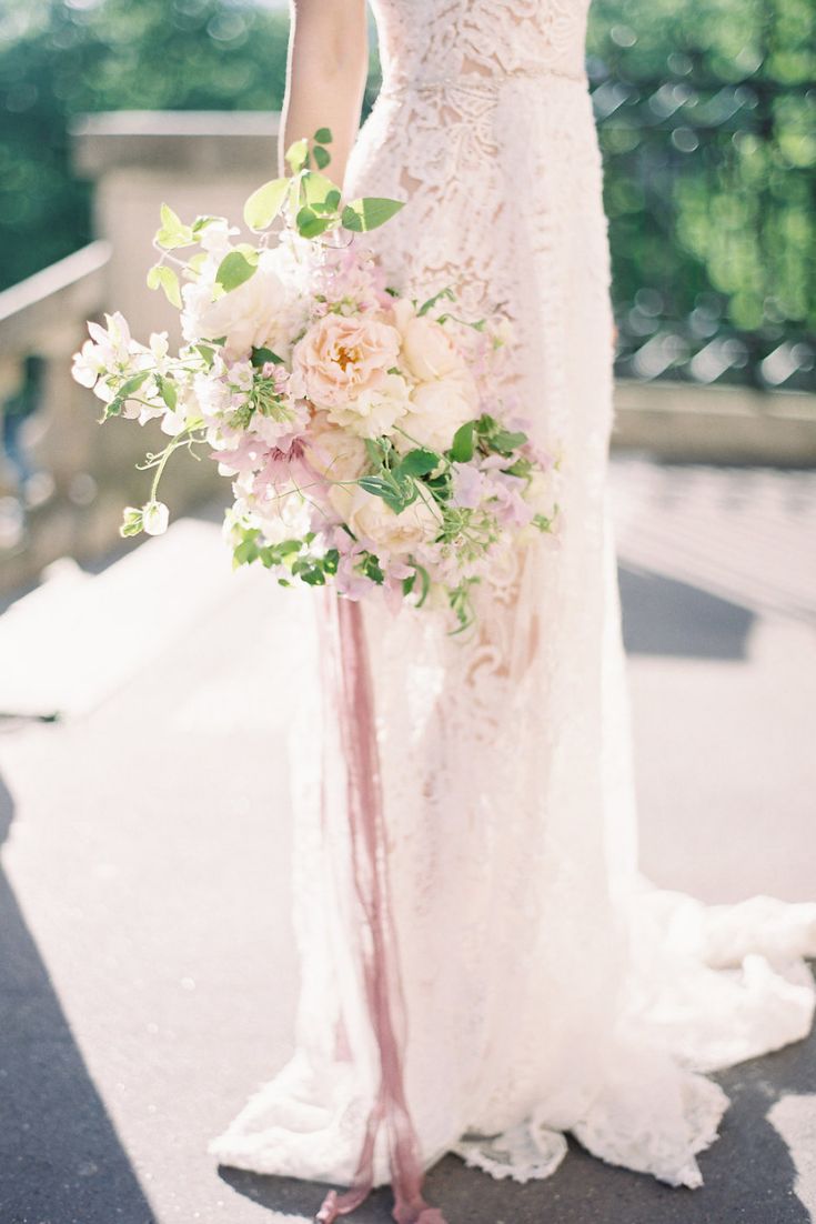 a woman in a wedding dress holding a bouquet