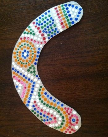 a colorful beaded object sitting on top of a wooden table