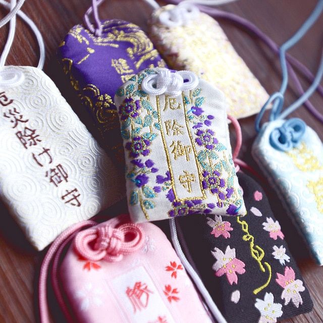 five small pouches with chinese writing on them sitting on top of a wooden table