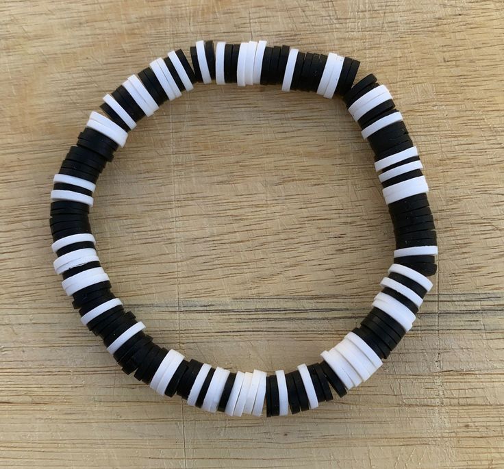 The Black and White Bracelet would make a perfect gift for a loved one or friend! Featuring clay beads in black and white. * Handmade in Texas - and made to order! * Bracelet length: 6.75" (standard) Materials: Black and white clay beads * Please measure your wrist before ordering as we do not offer returns or exchanges for resizing * You may request custom sizes in the personalization box. We can also make bracelets for children as well, but please measure their wrists for the most accurate fit. *These bracelets make great gifts for all occasions and are perfect for stacking or wearing alone! * All sales are final and no refunds will be issued. *Keep bracelet away from small children due to choking hazard *Keep bracelet dry and away from water and chemicals We will be adding new preppy br Boy Bracelet Ideas, Black Clay Bracelet, Bracelet Clay Bead, Bead Business, Bracelet Clay, New Preppy, Make Clay Beads, Keep Bracelet, Clay Bracelets