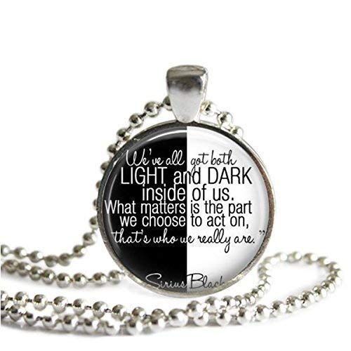 a necklace with the words light and dark on it, in black and white colors