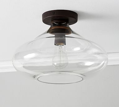 a clear glass light fixture hangs from the ceiling