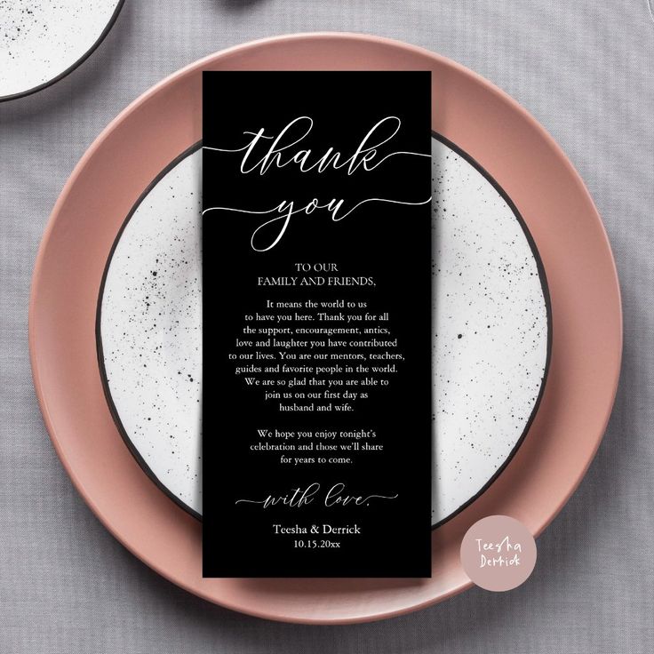 a black and white wedding thank card on a pink plate next to two silverware