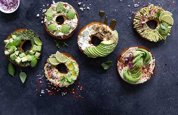 four bagels with avocado and other toppings