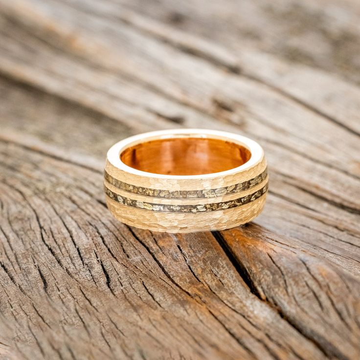 Product Details Ring Style: "Cosmo" is a custom, handcrafted domed men's wedding ring featuring a hammered band with gold nuggets inlays & copper lining. Additional inlay options are available upon request. Width: The width of the ring pictured is 8mm wide but can be ordered in a custom width accompanied by a design change fee. Please state your desired width in the Custom Requests section during checkout, and we will reach out to you for payment. Customizable: Because each ring is handcrafted t Staghead Designs, Hammered Band, Gold Nugget, Men's Wedding Ring, Detailed Ring, Hammered Gold, Ring Pictures, Unique Materials, Ring Style