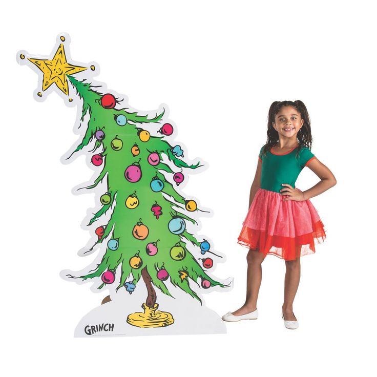 There's no mistaking the iconic wonky Christmas Tree from The Grinch! Add this stand-up decoration to your party supplies for a Grinch Christmas party or use it as classroom décor. Standing at over 5 ft. tall, this Christmas tree decoration makes a very Grinch-y statement! Pair the tree with our Dr. Seuss(TM) The Grinch Cardboard Stand-Up (13910468) to complete your Grinch theme! Cardboard. 44" x 64 1/2" Stand-ups are one-sided with a brown cardboard back. Simple assembly required. © OTC / (TM) Dr Seuss Christmas Tree, Christmas Tree Cardboard, Whoville Christmas Tree, The Grinch Christmas Tree, Tree Cardboard, Dr Seuss Decorations, Grinch Door, Cardboard Stand, Grinch Trees