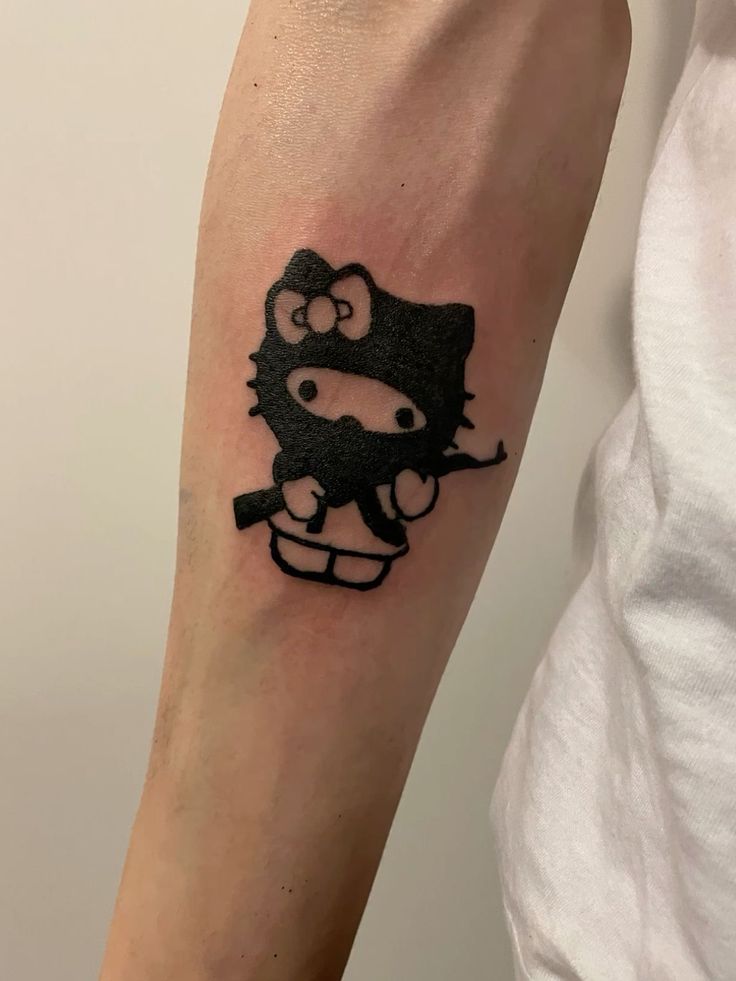 a hello kitty tattoo on the arm