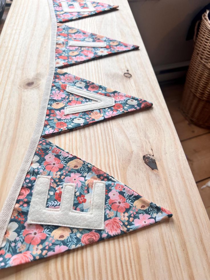 several pieces of fabric laid out on top of a wooden table