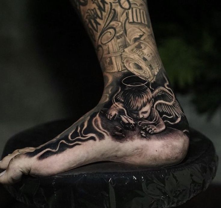 a man's foot with tattoos on it