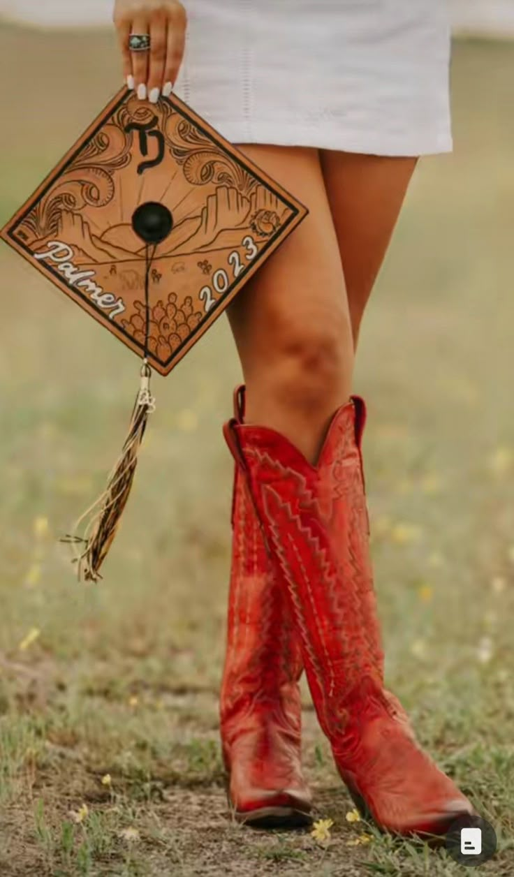 a woman wearing red cowboy boots and holding a brown bag with an arrow on it