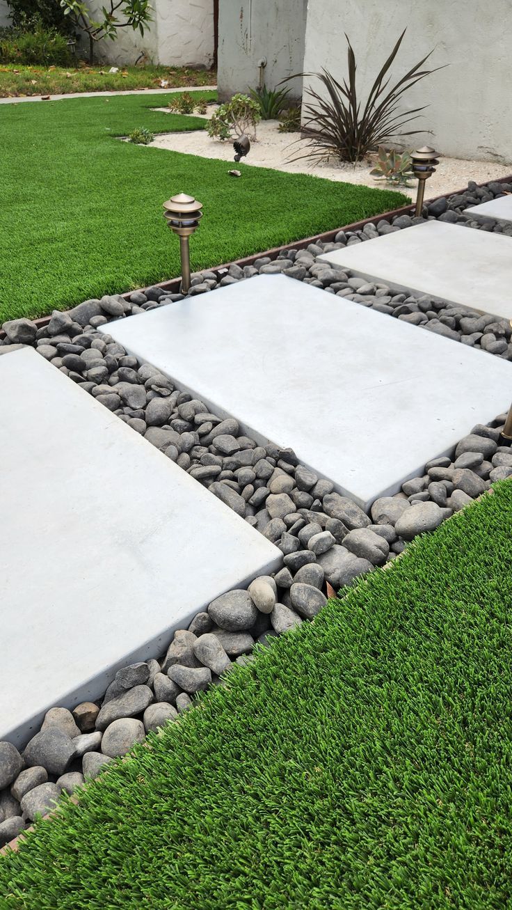 an outdoor area with grass, rocks and stones