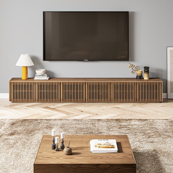 a flat screen tv mounted to the side of a wooden entertainment center in a living room