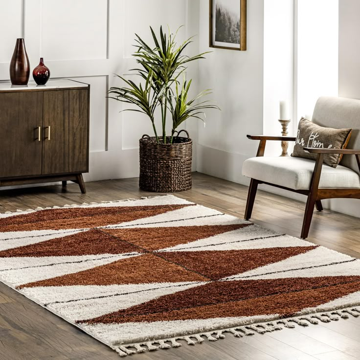 a brown and white rug in a living room next to a wooden cabinet with two vases on it