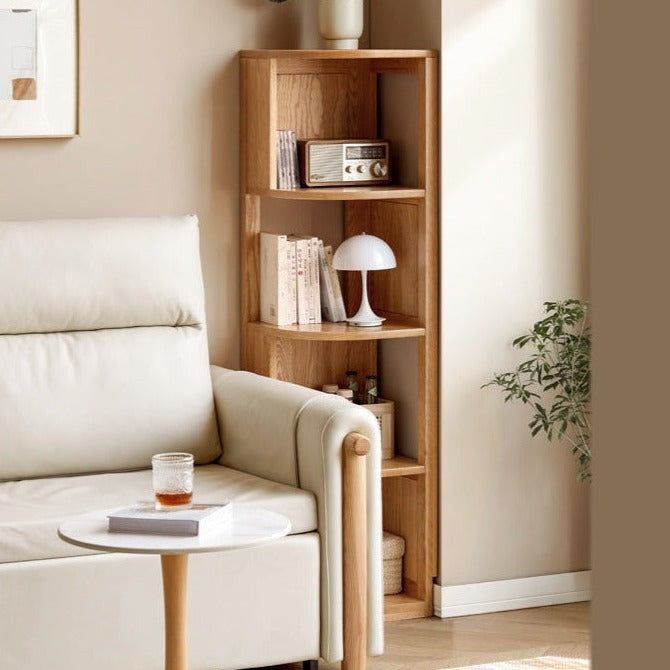 a living room with a white couch and wooden shelves