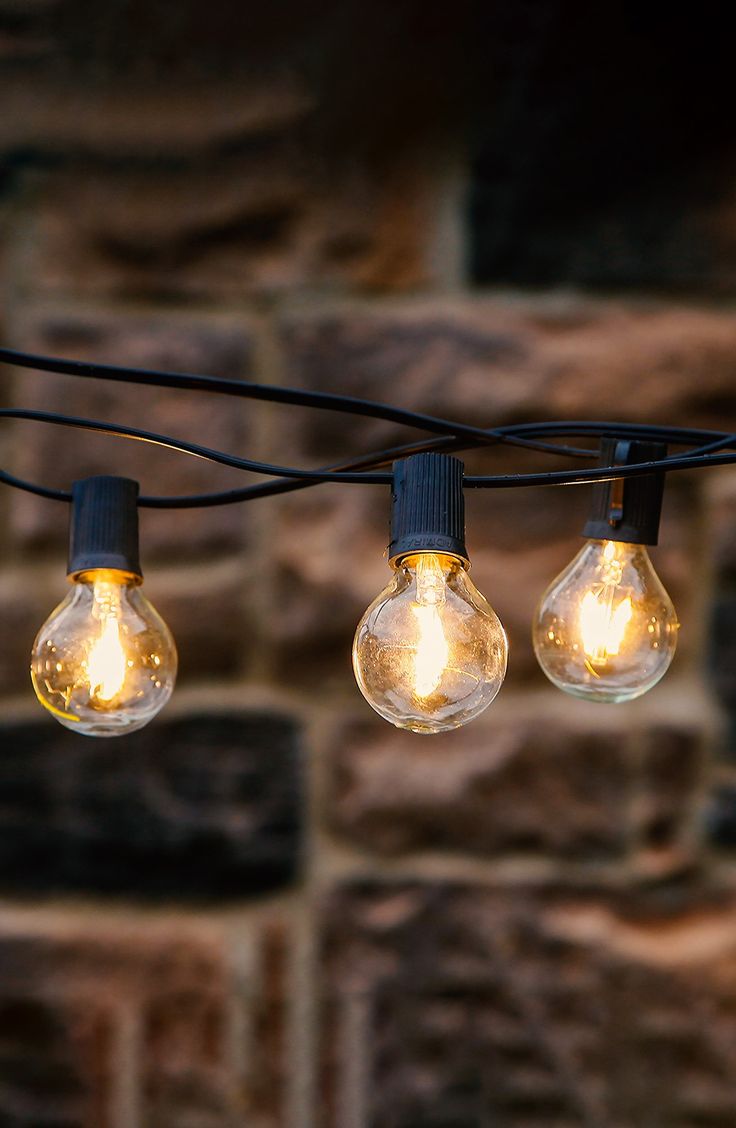 some light bulbs are hanging from a wire