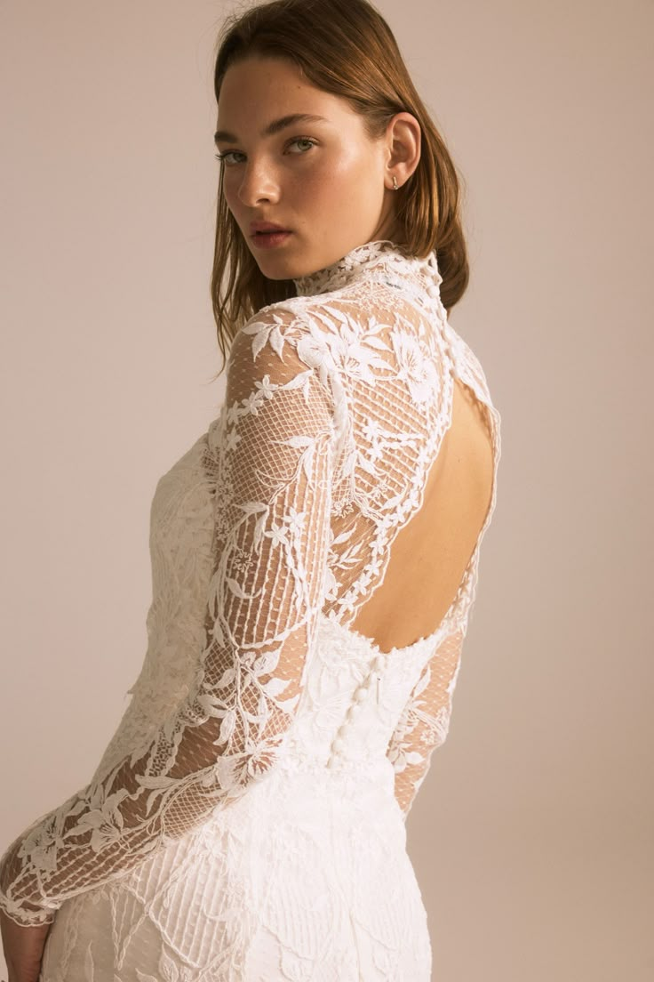 a woman wearing a white dress with lace on it