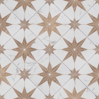 a white and brown tiled floor with star designs on it's sides, in the middle